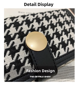Close-up of houndstooth fabric texture with leather trim and gold snap button on wallet