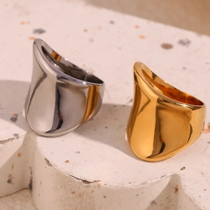 Detail of minimalist irregular wide geometric rings in gold and silver stainless steel