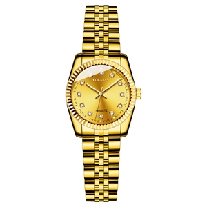 Detail of gold quartz watch featuring a diamond-encrusted dial and sleek steel band