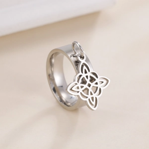 Macro shot of silver witch knot pendant on a high-polished stainless steel ring