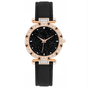 Detailed macro of rose gold floral bezel with rhinestones and starry black dial
