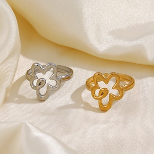 Exaggerated floral hollow out ring in gold and silver finish on silk background