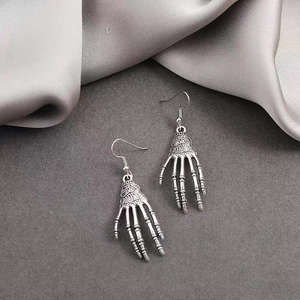Gothic skull hand earrings in vintage silver metal, perfect for Halloween accessory styles