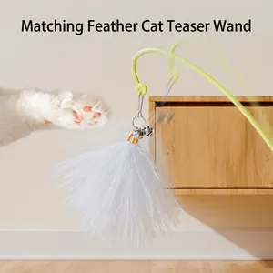 Interactive tumbler cat toy with white feather wand and bells in a home setting