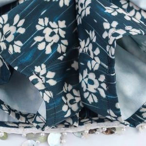 Macro detail of floral print fabric with exquisite pearl and shell beaded edge trim