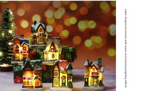 Glow-in-the-dark resin Christmas cottage with warm LED lights and faux snow detail