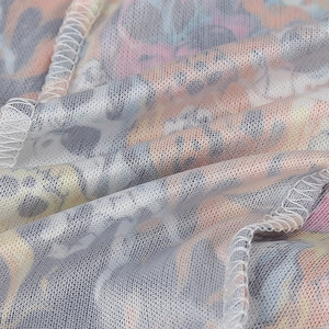 Close-up of the breathable mesh fabric with vibrant paisley patterns and clean edge stitching