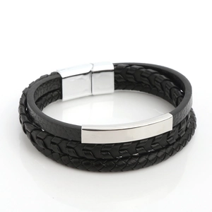Detail view of multi-layer black braided leather bracelet with silver magnetic clasp