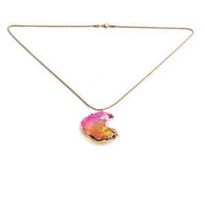 Detail of crescent moon pendant with pink to yellow gradient crystal and gold twist chain