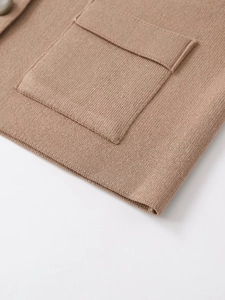 Close-up of a camel knit cardigan showing fine texture, pocket detail and soft material