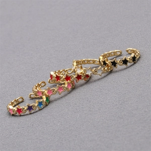 Detailed view of colorful star rings in pink, red, blue, and black enamel finishes