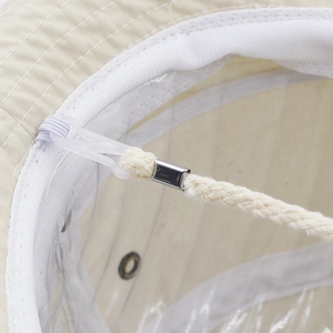 Detail showing the adjustable windproof rope and durable metal buckle on beige sun hat