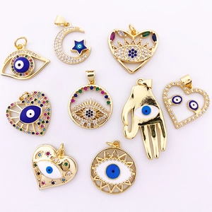 Detail of eight golden evil eye pendants with sparkling cubic zirconia for DIY jewelry