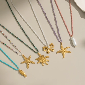 Marine beaded necklace collection with golden starfish, turtle, and pearl pendants