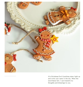 Close-up of hand-painted resin gingerbread man ornaments on a vintage white plate