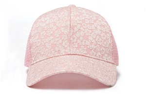 Detailed close-up view of pink mesh baseball cap with white floral lace embroidery