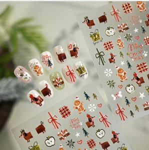 Detail view of Christmas nail stickers featuring dachshunds, gingerbread and bows