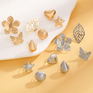 Detailed set of gold and silver ear clips in star, flower, and heart shapes for women