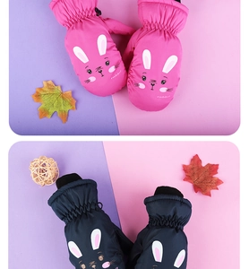 Detail view of pink and navy blue winter ski mittens with cute rabbit ears for children
