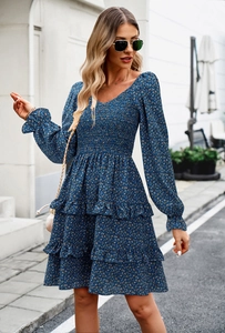 Blue floral long sleeve dress with puff sleeves and tiered ruffle hem on a street backdrop