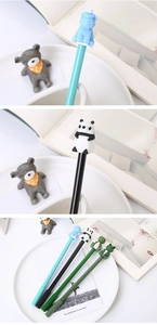 Detail shot of cute 3D silicone animal toppers including bear and panda on neutral pens