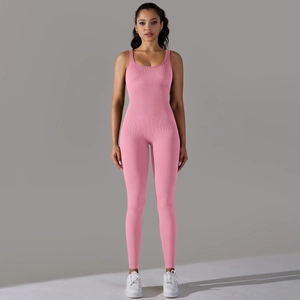 Detail of pink ribbed seamless yoga jumpsuit showing the stretch knit texture and fit
