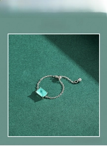 Detail of adjustable S925 silver chain ring with rectangular blue-green gemstone