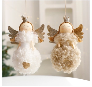 Close-up of plush Easter angel ornaments with glitter wings and warm home decor background