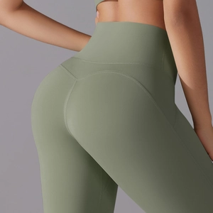 Detail of high-waist yoga shorts in sage green with V-shaped back seam for butt lifting