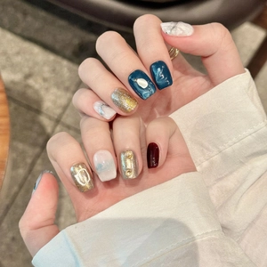 Handmade navy blue marble and gold glitter press-on nails with pearl and bead accents