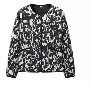Detail of quilted jacket with abstract black and white print and size XS label
