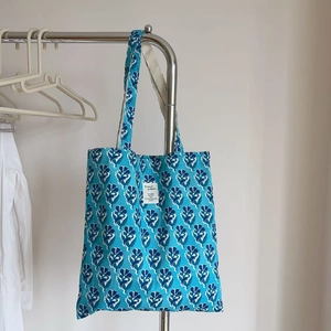 Detail of blue and white floral pattern on vintage cotton canvas tote bag with tag