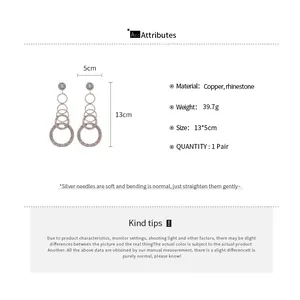 Detail view showing size measurements of sparkling rhinestone tassel round earrings