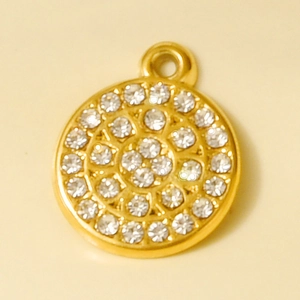Close-up of golden circular pendant featuring concentric rows of sparkling crystals