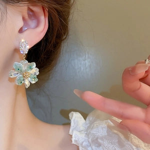 Elegant floral drop earrings with diamond studs and pale green translucent petals