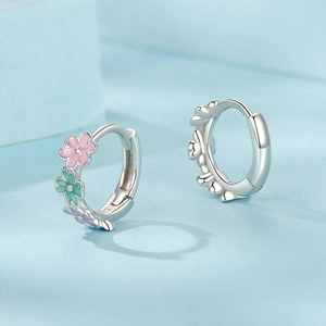 S925 sterling silver hoop earrings with colorful enamel flowers on a blue background