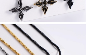 Detail of gothic style cross pendants in gold, silver, and black metal finishes