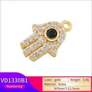 Gold Hamsa Hand pendant with white zircon micro-paving and black center stone
