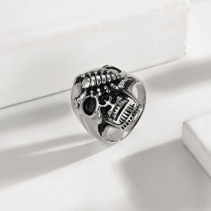 Macro shot of silver vintage-style punk skull ring with detailed polished finish