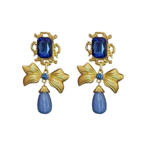 Vintage geometric bow earrings with blue teardrop crystals and gold finish