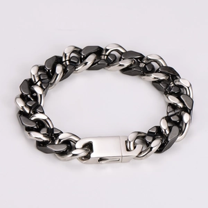 Detailed view of two-tone hip-hop Cuban chain bracelet in silver and gun-black finish