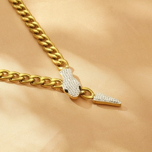 Close-up of golden snake-shaped cuban chain necklace with glittering rhinestones