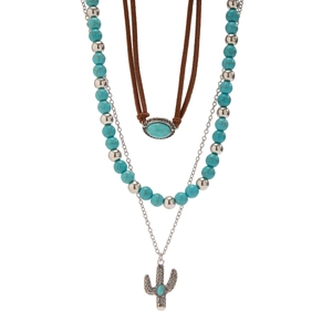 Close-up of bohemian layered necklace with turquoise beads and cactus pendant
