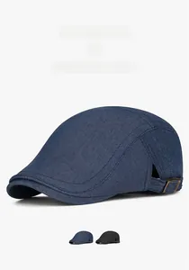 Close-up of denim flat cap showing metal side buckle and high-quality fabric texture
