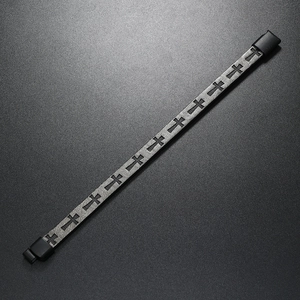 Detailed macro view of the black alloy cross pattern and magnetic clasp on men's bracelet