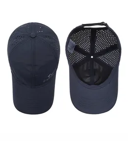 Detail view of navy blue outdoor baseball cap showing laser-cut ventilation and inner tag