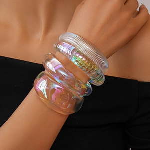 Macro shot of colorful iridescent acrylic bangles with textured and smooth finishes