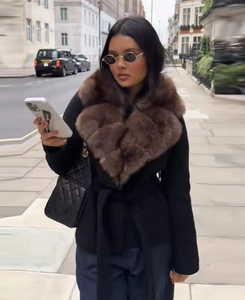 Detail showing elegant long sleeve coat with luxury brown faux fur collar and waist tie