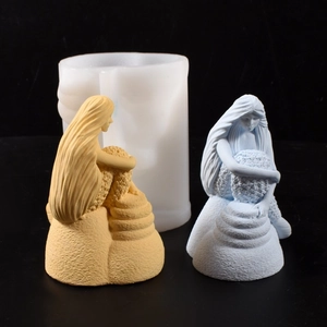 Detail of 3D mermaid silicone mold with two finished scented candle statues in blue and yellow