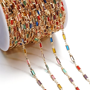 Detailed macro view of gold-plated DIY chain with rectangular colorful crystals for jewelry